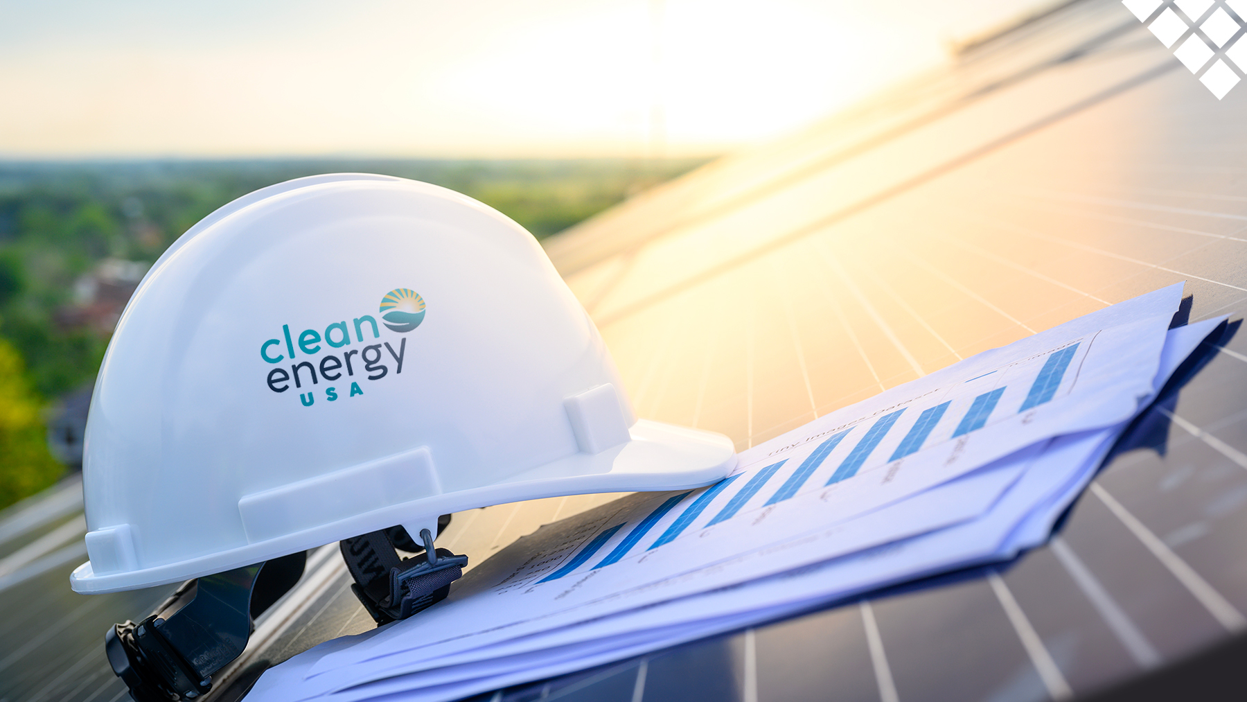 Hard Hat with clean energy USA logo sitting atop a solar panel on a roof