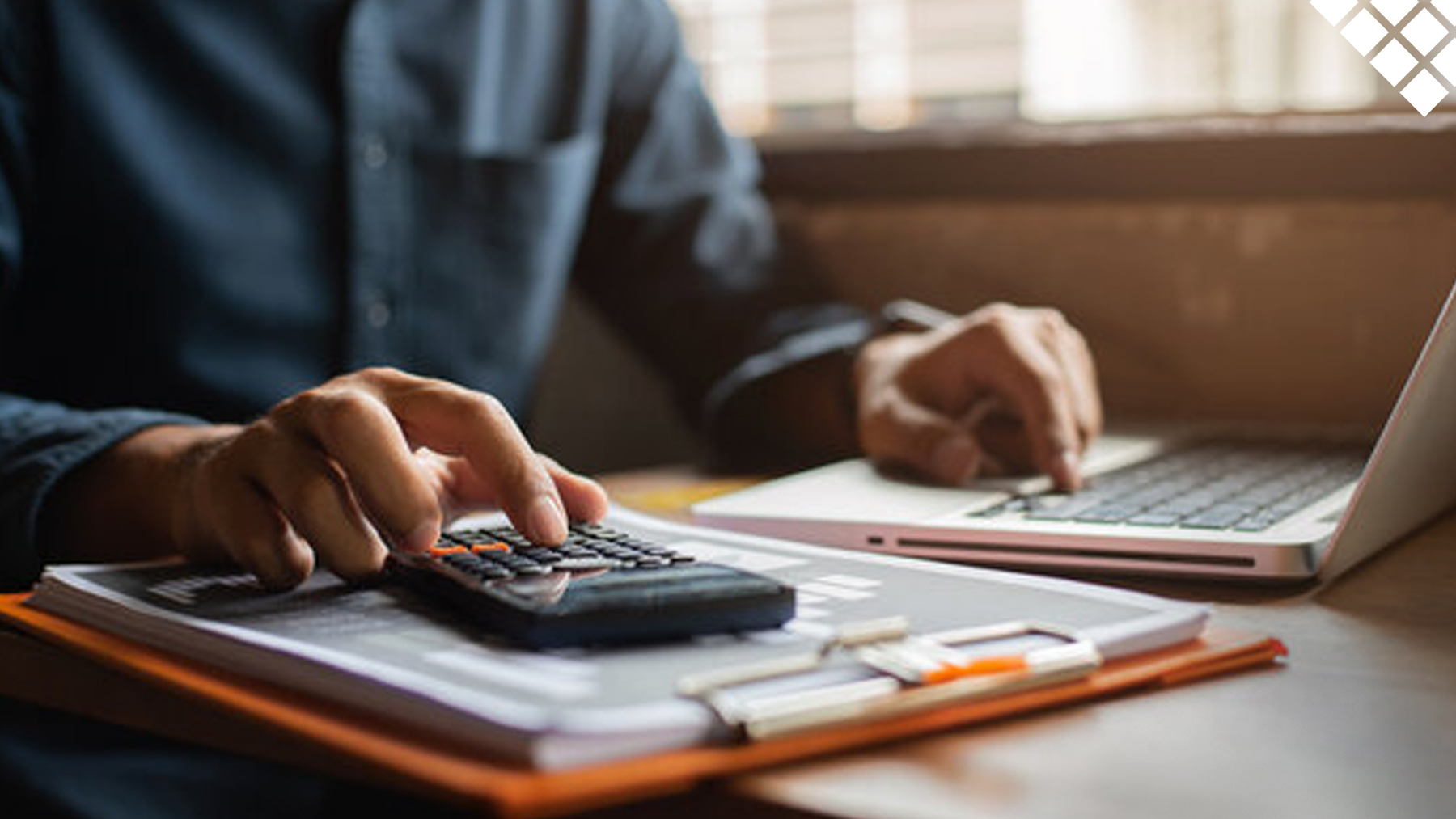 Man typing on calculator doing taxes