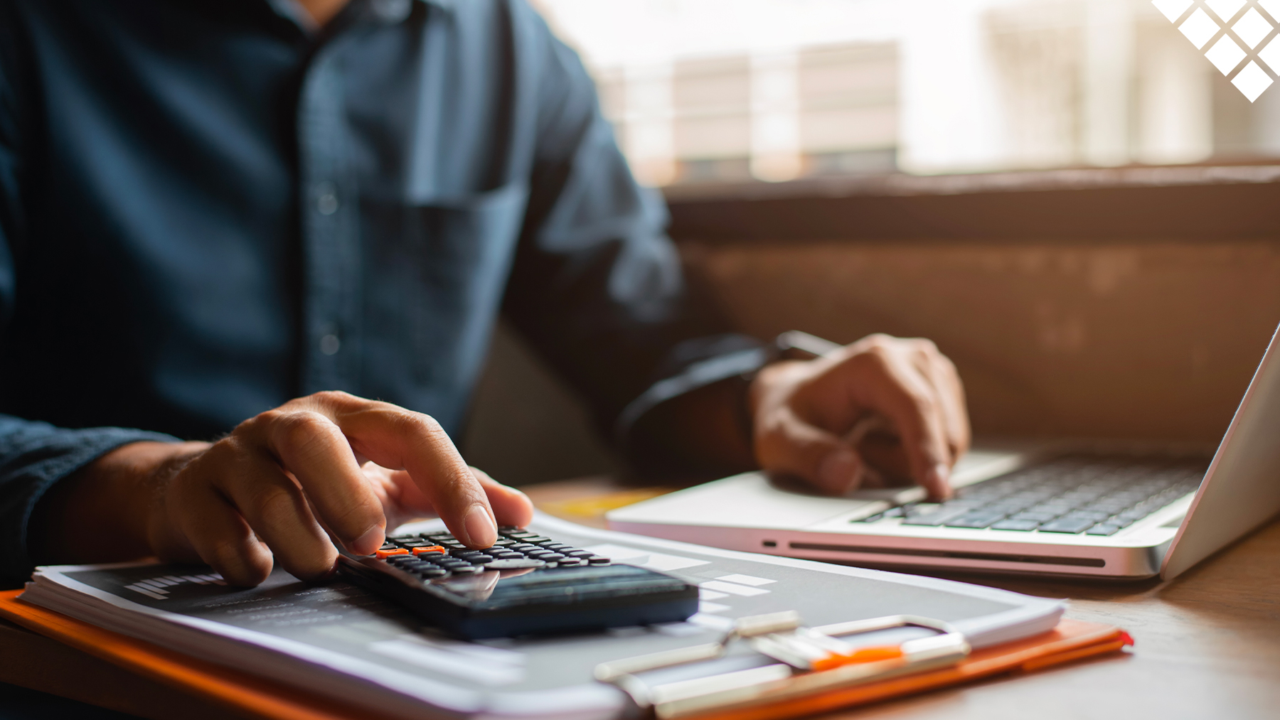 Man using calculator to work out finances and budget