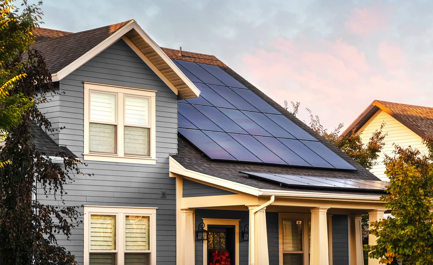 Home with beautiful sky and solar panels on roof