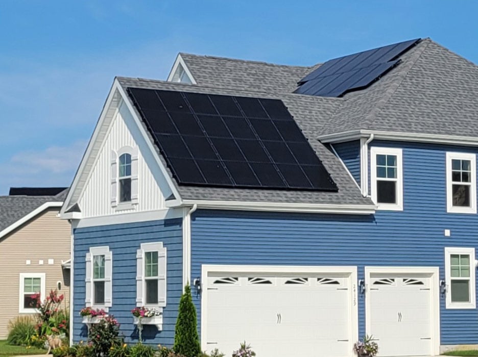 Home with beautiful sky and solar panels on roof