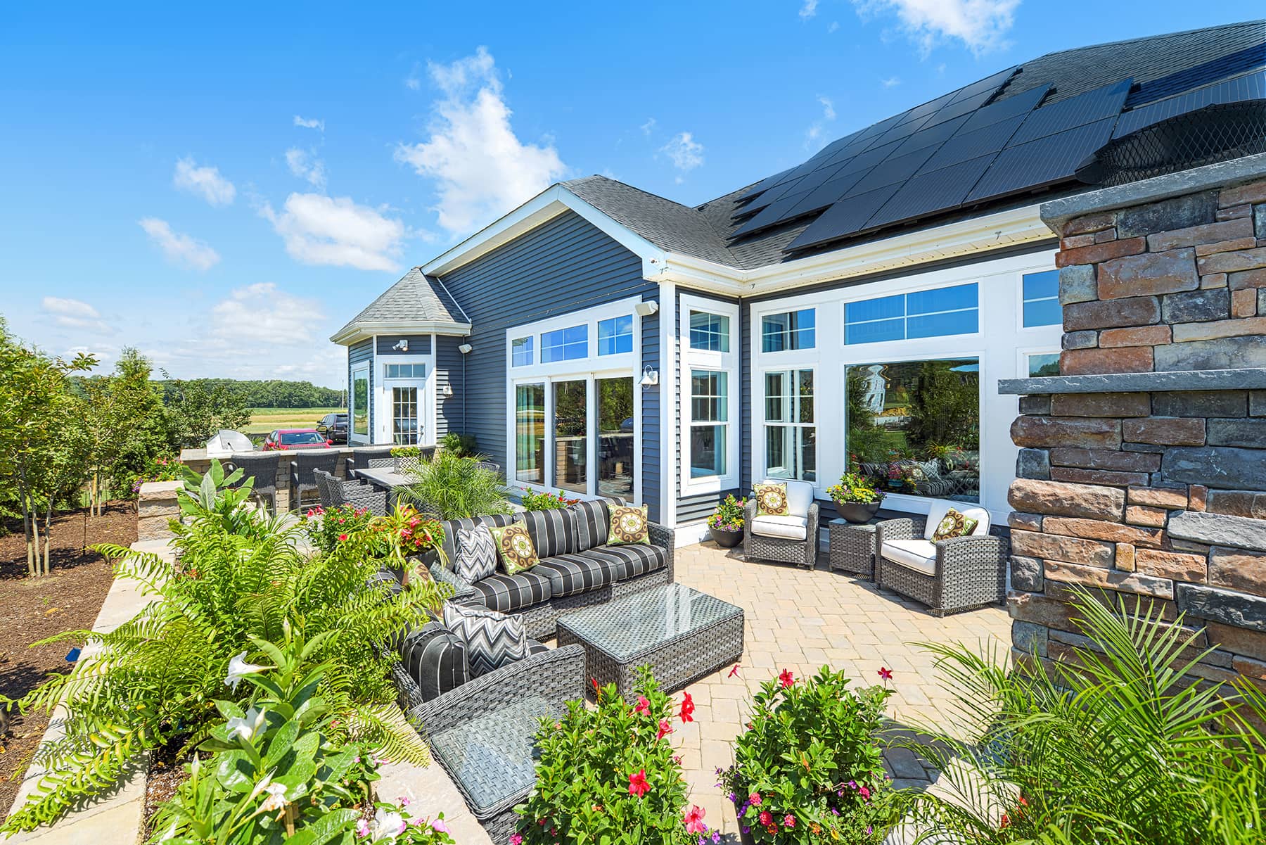 Beautiful shot of backyard with solar panels on roof of house