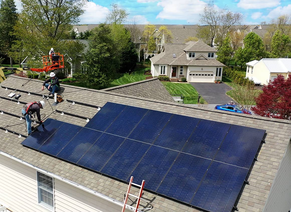 Clean Energy USA workers installing solar panels on residential home roof