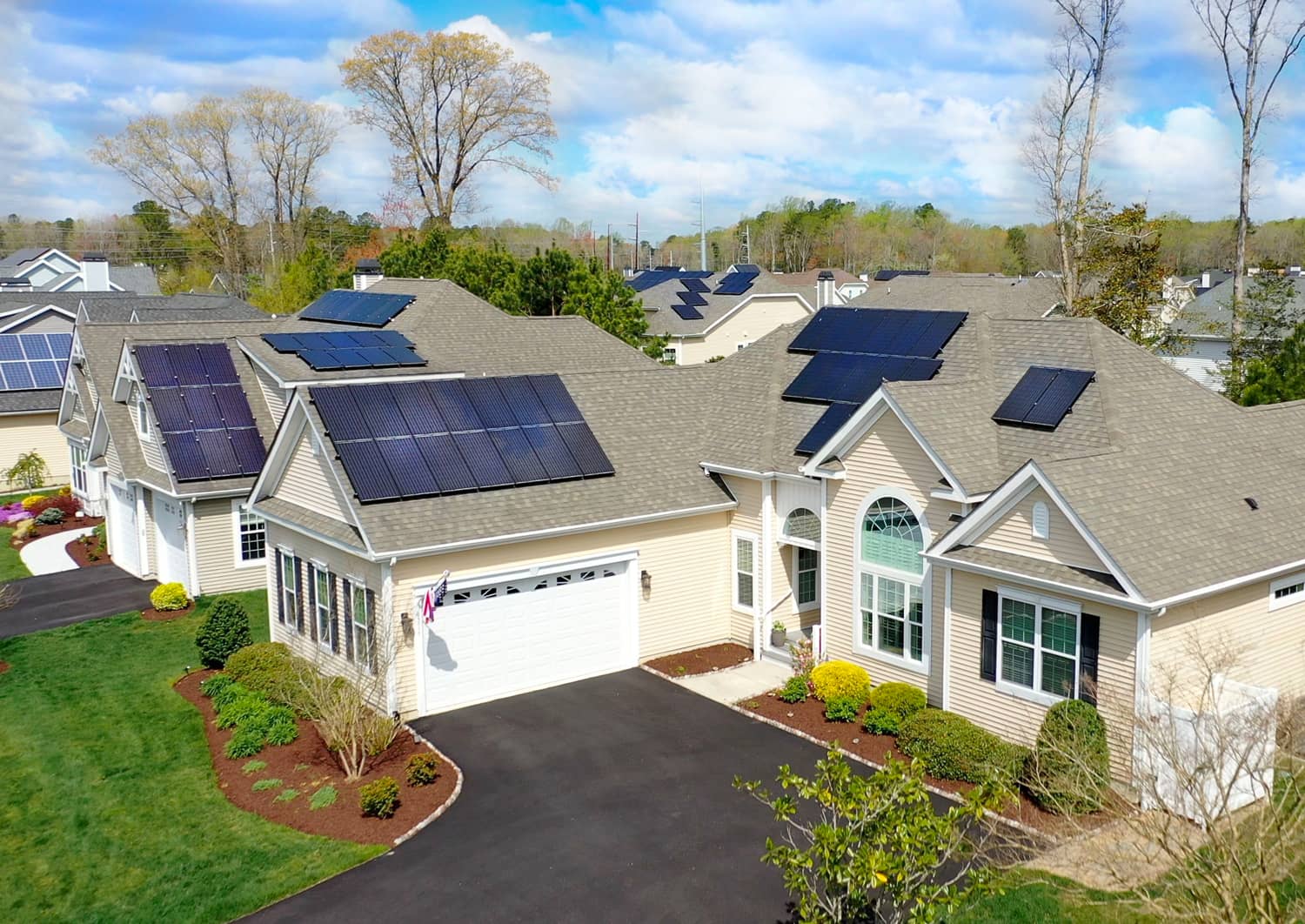 Overhead view of neighborhood and house with solar panels on roof